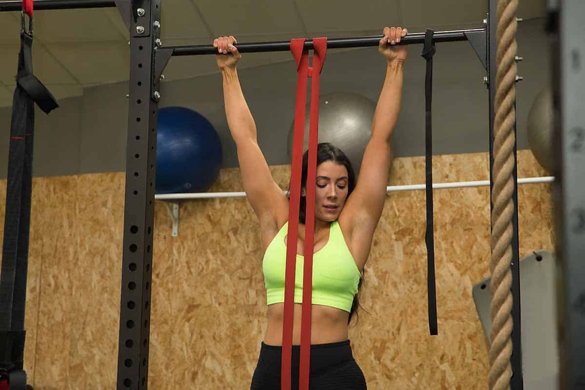 woman doing assisted pull-ups with band