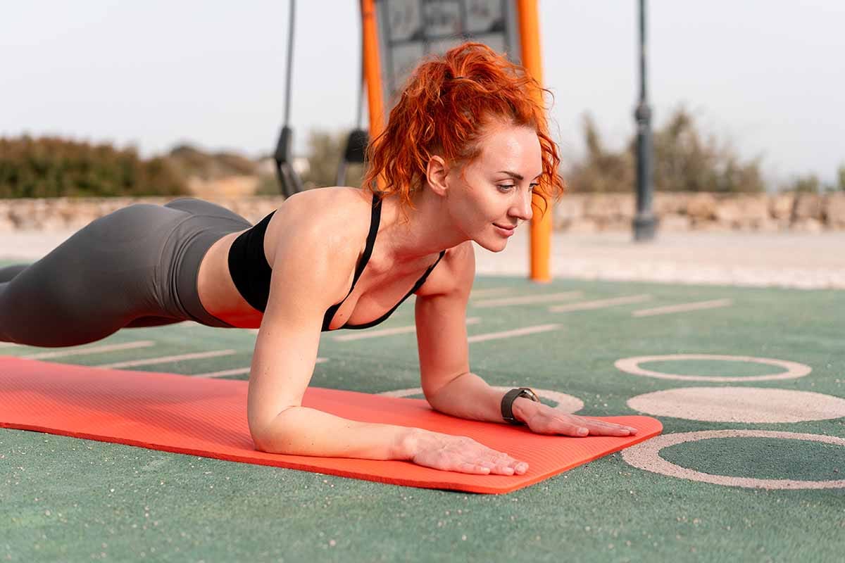 young athlete girl doing long lever plank 