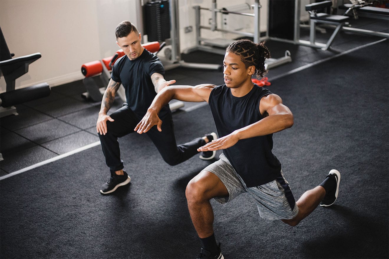 A personal trainer with their client, answering the question: are personal trainers worth it?