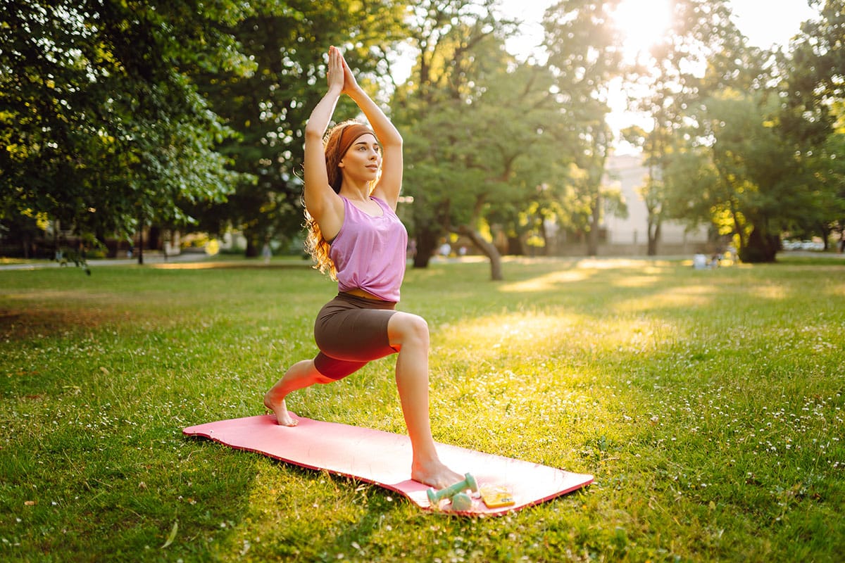 A woman does yoga as a low-impact workout