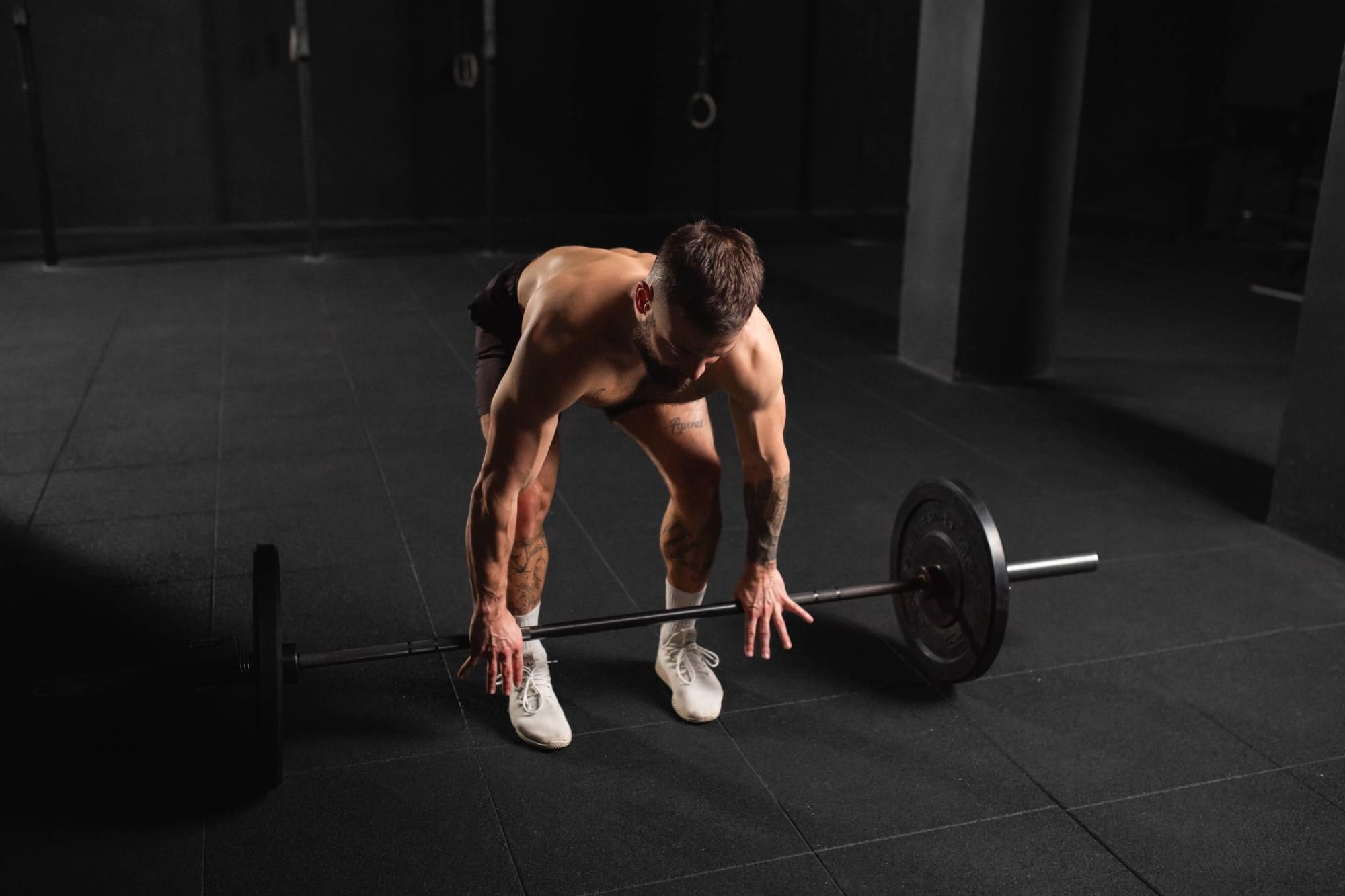 Athletic man performing a deadlift in a gym